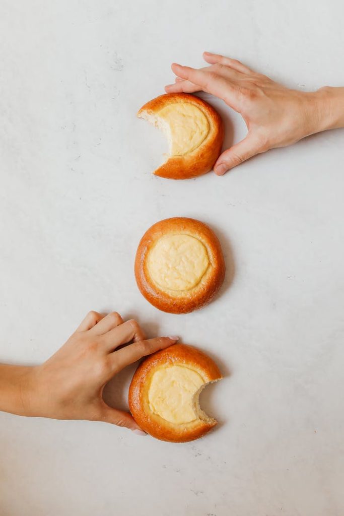 Close-Up Shot of Two People Holding Vatrushki